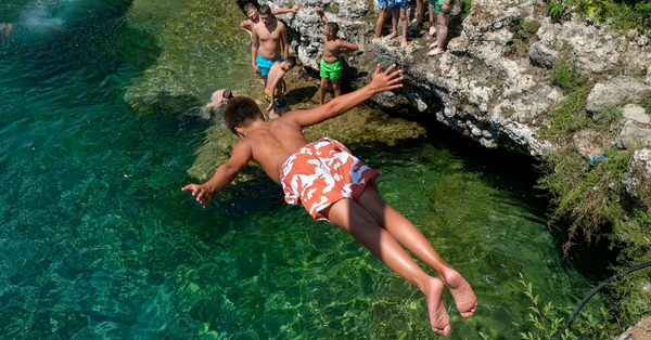 黑山首都波德里查的氣溫達36度，一名男孩跳進河中消暑